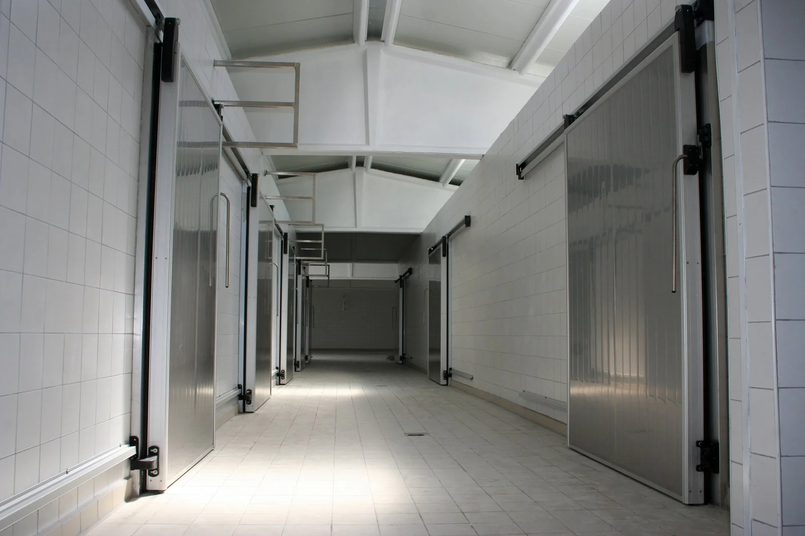 Insulated cold-room doors along a refrigerated warehouse corridor